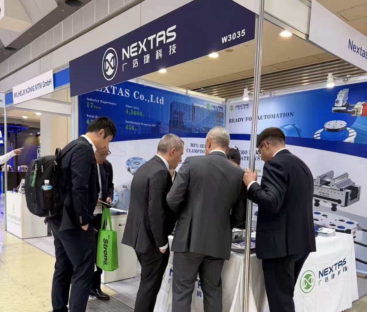 Visitors gathered at the NEXTAS booth under a header that reads W3035